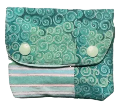 Fabric pouch with green swirl pattern and white buttons on a white background