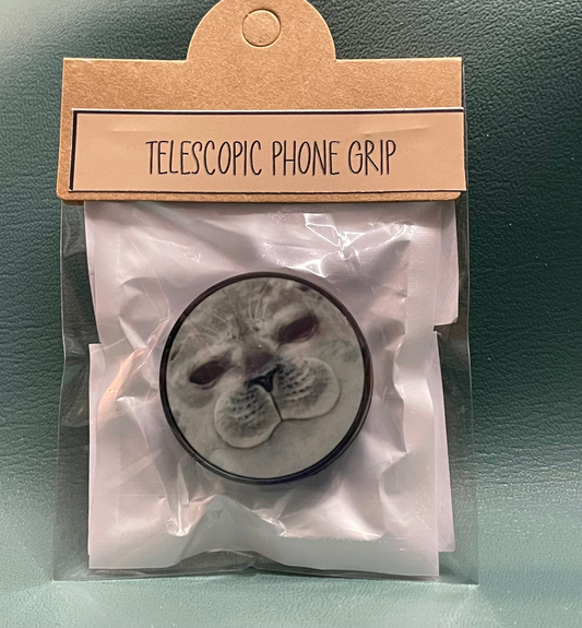 Seal themed Telescopic phone grip packaging with a cardboard label on a green surface