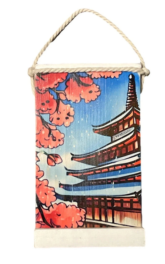 Decorative wall hanging with cherry blossoms and a traditional Japanese temple design.