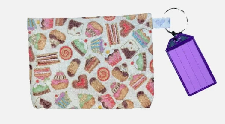 Pouch with colorful dessert pattern and keychain with purple tag on a white background