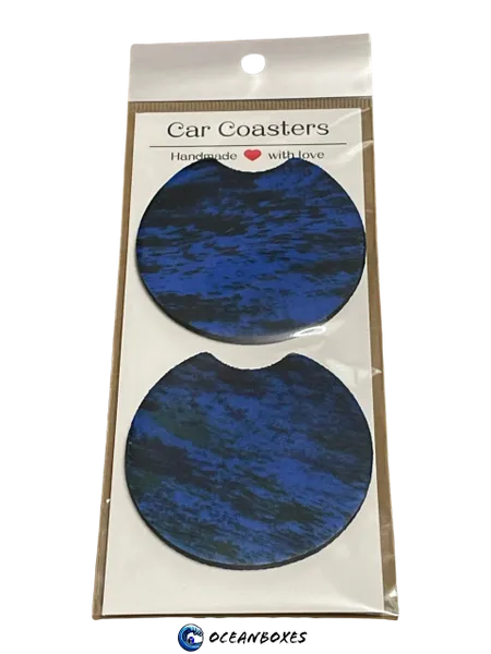 Two blue car coasters in a clear plastic package with Oceanboxes branding.