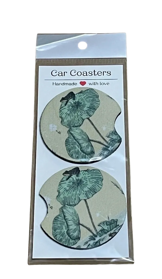 Pack of car coasters with frog design in packaging on a white background
