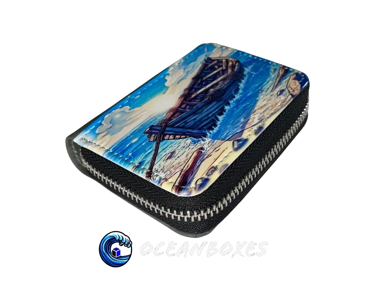 Zipper pouch with a painting of a boat on a beach, branded 'oceanboxes'.