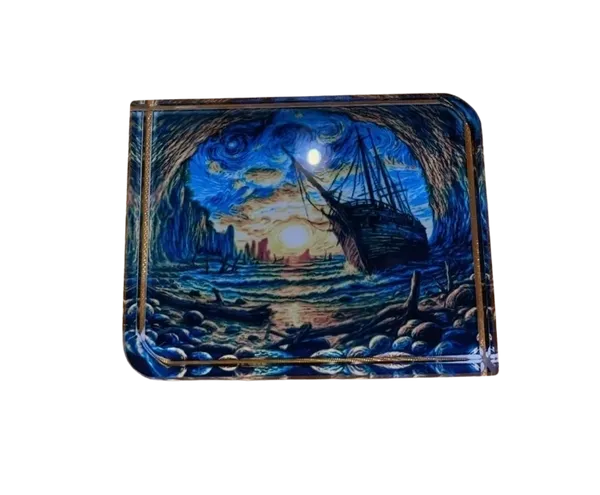 Decorative paper weight with a ship and landscape design on a white background