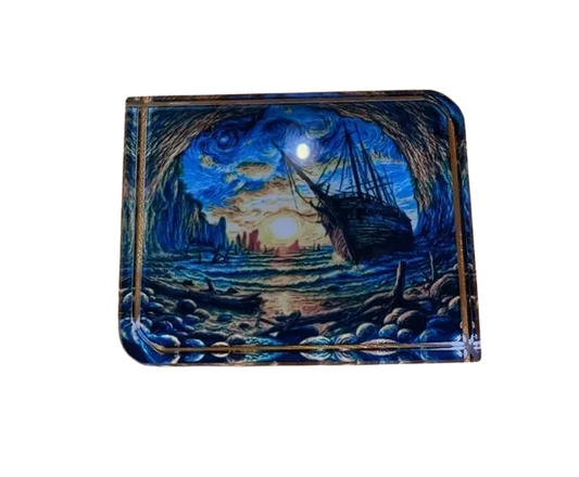 Decorative paper weight with a ship and landscape design on a white background