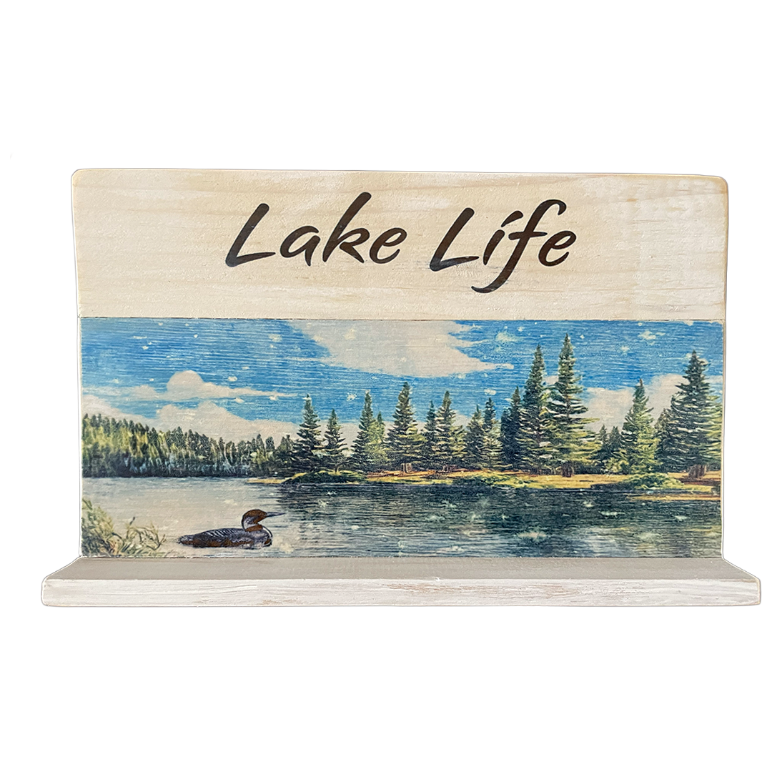 Decorative sign with 'Lake Life' text and a lake scene on a white background