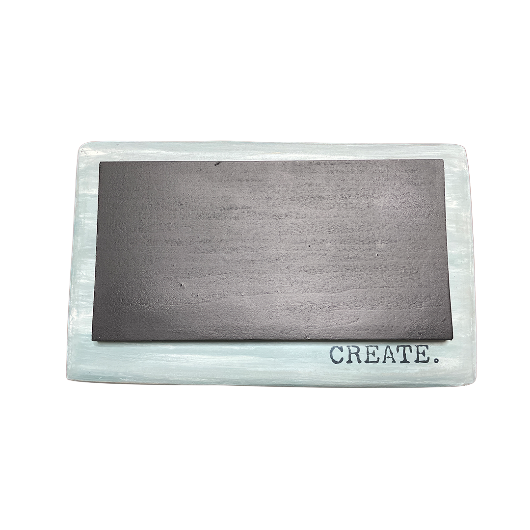 Rectangular metal block with 'CREATE.' on a white background