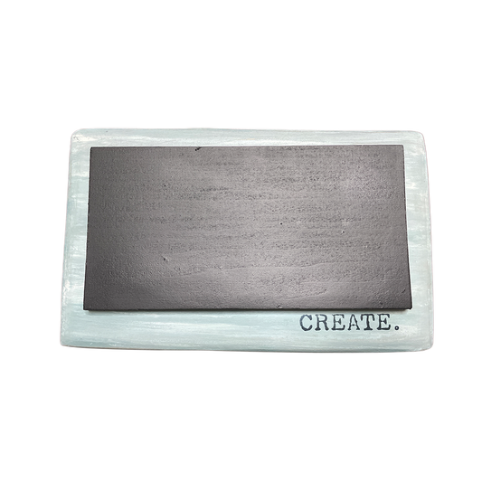 Rectangular metal block with 'CREATE.' on a white background