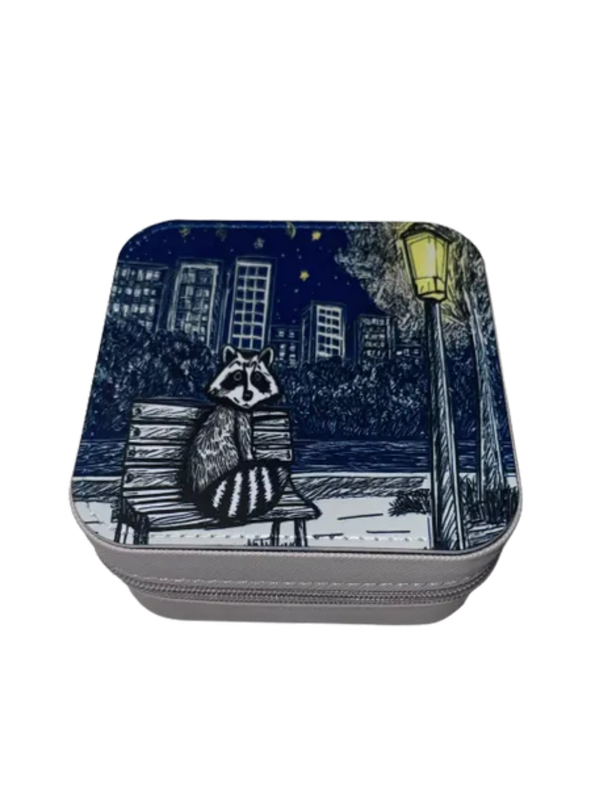 Square zippered box with a raccoon design on a bench at night, featuring a cityscape.